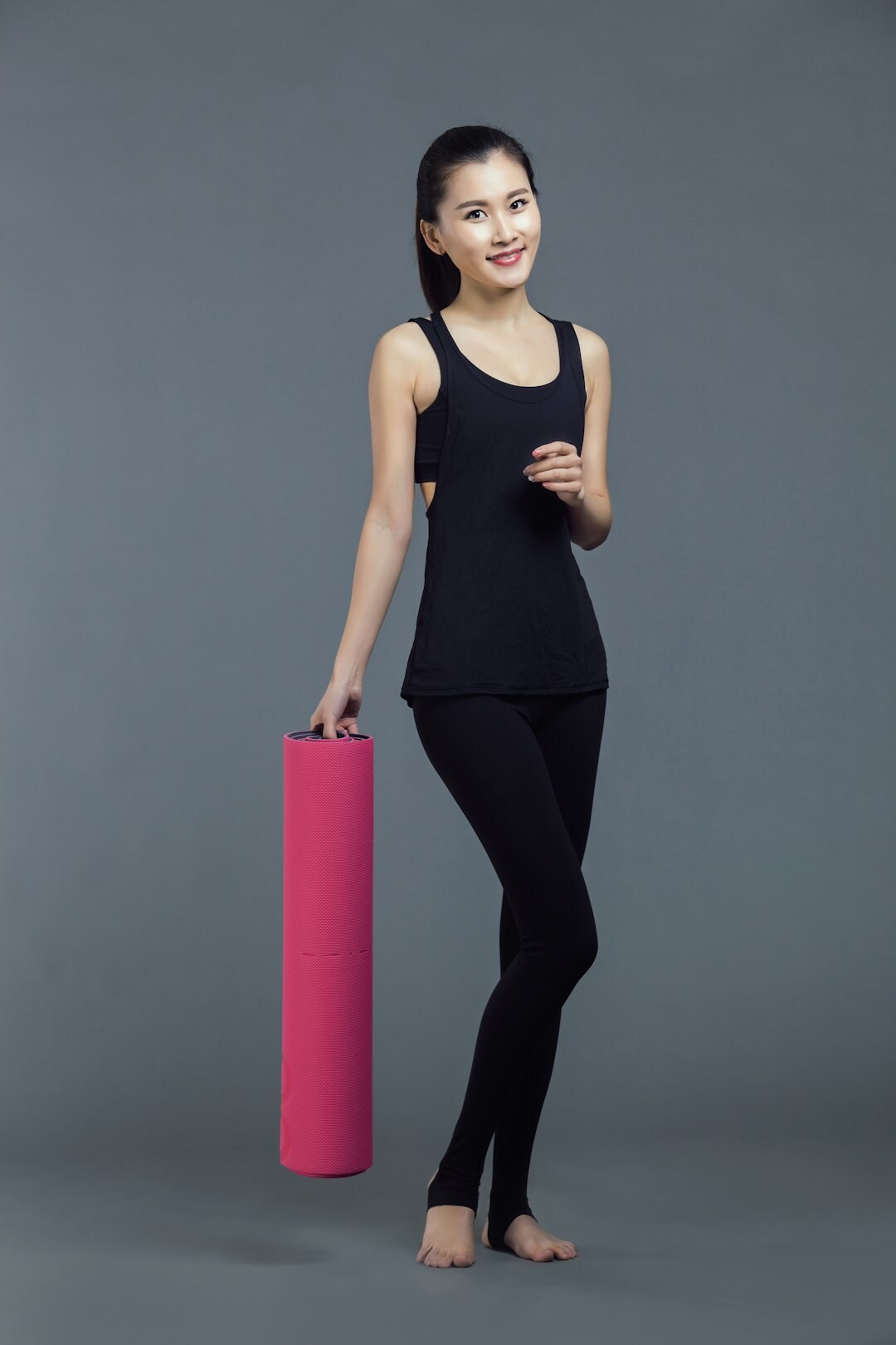 Studio portrait of a smiling Chinese Singaporean woman instructor in business casual attire