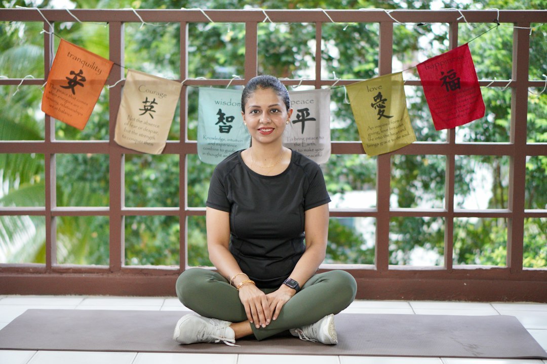 Studio portrait of a smiling Indian Singaporean woman instructor in business casual attire